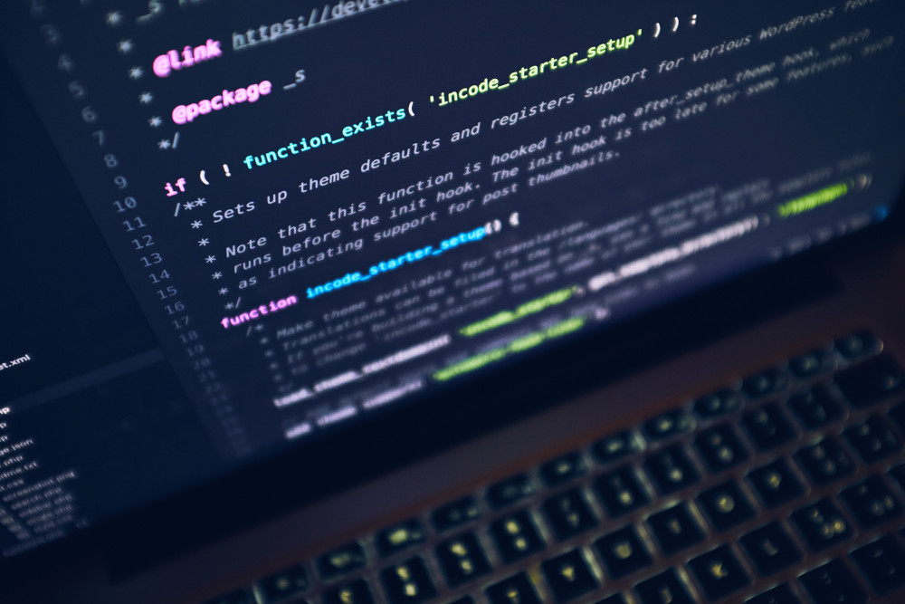 Photo of a laptop screen with code on it